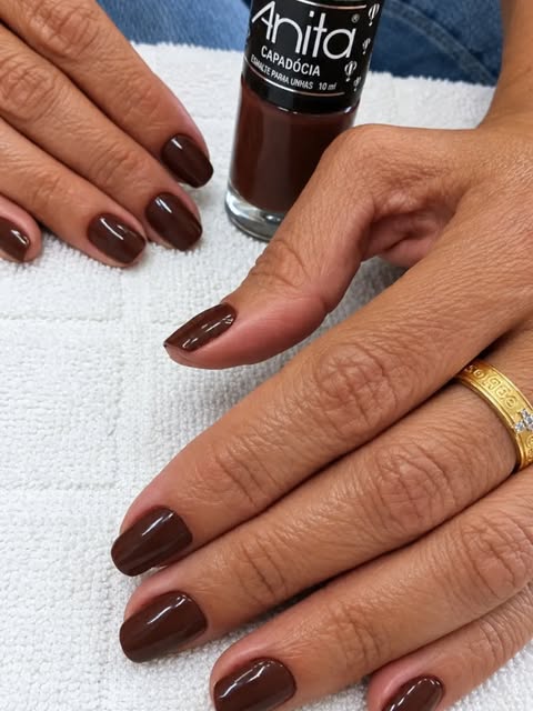 Unhas esmaltadas em marrom chocolate